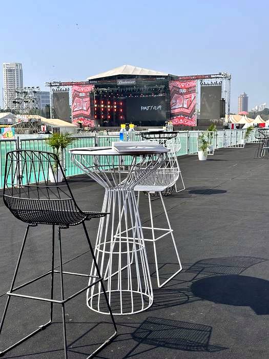VIP lounge deck with cocktail furniture facing stage