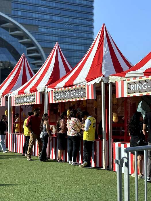 Striped canopy tents at a festival activation zone